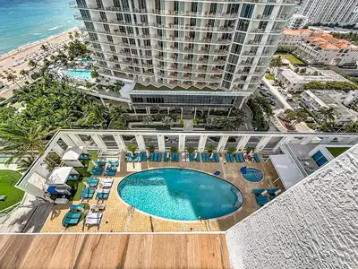 an aerial view of a building with a pool and chairs at Stylish 1 BR at Fort Lauderdale in Fort Lauderdale