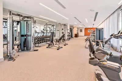 a large gym with treadmills and cardio machines at Luxury 1BD/1BT Apartment in Downtown Doral in Miami
