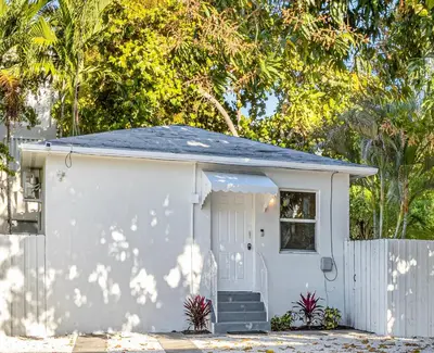 a small white shed with a white fence at Beautiful Casita with King Bed and private patio Close to Calle 8, MIA Airport, Coral Gables in Miami