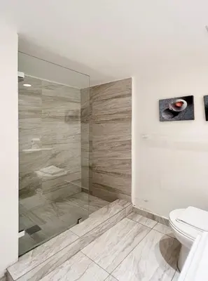 a bathroom with a shower and a toilet at South Beach Apartments in Miami Beach