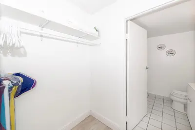 a white bathroom with a toilet and a shower at South Beach Apartments in Miami Beach
