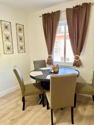 a dining room with a blue table and chairs at Enchanting cozy Apartment 10 min away from airport, Calle 8, Brickell, Coral Gables, the beach and more! in Miami