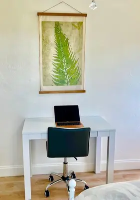 a white desk with a laptop on top of it at Enchanting cozy Apartment 10 min away from airport, Calle 8, Brickell, Coral Gables, the beach and more! in Miami