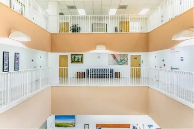 a view of the inside of a building with white and orange ceilings at South River Suites in Medley