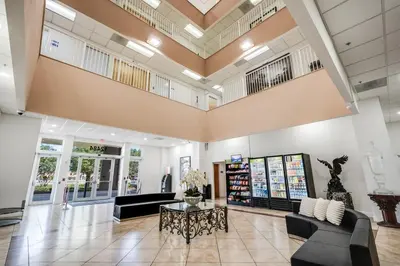 a lobby of a store with couches and a table at South River Suites in Medley
