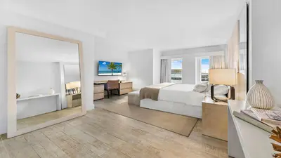 a bedroom with a bed and a large mirror at Luxurious Private Condo at 1 Hotel & Homes -945 in Miami Beach