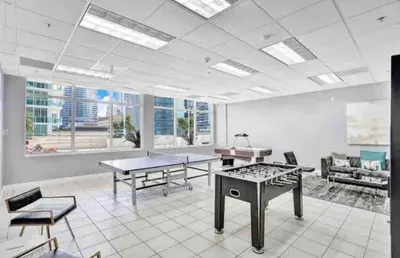 a large room with tables and chairs in a building at Luxurious Condo with PARKING in Brickell Miami in Miami