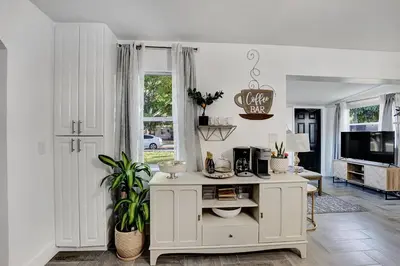 a living room with a white cabinet and a tv at Casa Del Sol in Hollywood