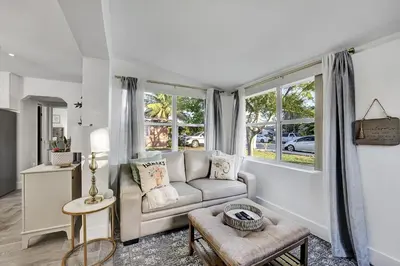 a living room with a couch and some windows at Casa Del Sol in Hollywood