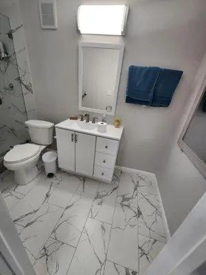 a bathroom with a sink and a toilet and a mirror at Private and beautiful room for vacation in Carver Ranches