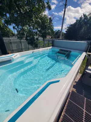 a lap pool with blue water in a backyard at Private and beautiful room for vacation in Carver Ranches