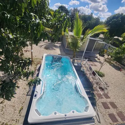 a hot tub in the backyard of a house at Private and beautiful room for vacation in Carver Ranches