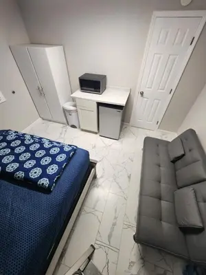 a bedroom with a bed and a chair and a desk at Private and beautiful room for vacation in Carver Ranches