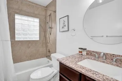 a bathroom with a sink and a toilet and a mirror at Beach House w/ Heated Pool in Hollywood
