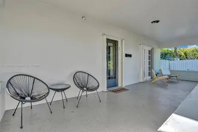 a living room with two chairs and a table at Beach House w/ Heated Pool in Hollywood