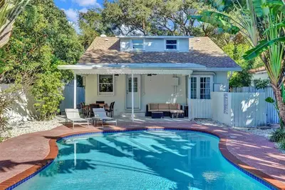 a swimming pool in front of a house at Beach House w/ Heated Pool in Hollywood