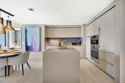 a kitchen with a counter and a dining room at Exclusive Condo - Near Beach - Free Valet Parking in Hollywood