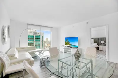 a living room with a glass table and white furniture at Amazing Penthouse In beautiful Brickell 42 floor!! Free Garage Parking in Miami