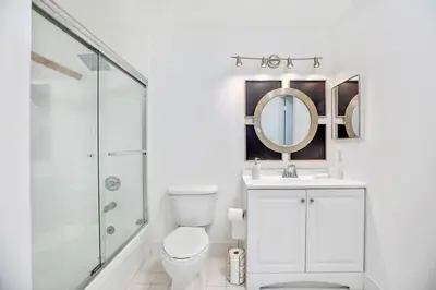 a white bathroom with a toilet and a mirror at Amazing Penthouse In beautiful Brickell 42 floor!! Free Garage Parking in Miami