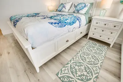 a white bedroom with a bed and a nightstand at Sunny Isles Beach Retreat with Resort Perks! in Miami Beach