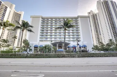 an empty street in front of a large building at Sunny Isles Beach Retreat with Resort Perks! in Miami Beach