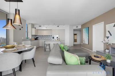 a living room and kitchen with a couch and a table at Luxury 3 Br - Corner Balcony - Panoramic View - Pools in Hollywood