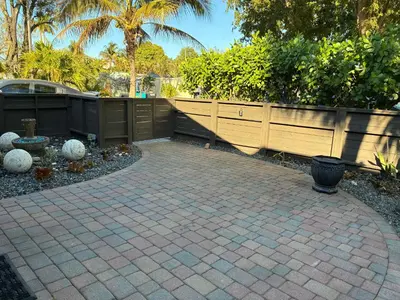 a backyard with a brick patio and a fence at HEART OF WILTON MANORS in Fort Lauderdale