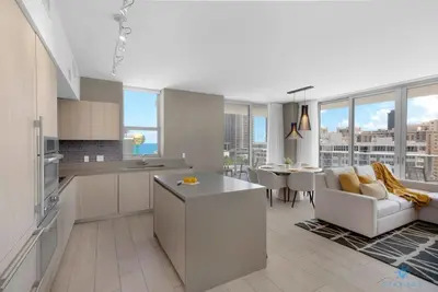 a kitchen and living room with a view of a city at Wrap Around Balcony, Paradise Beach & Amazing Pools in Hollywood