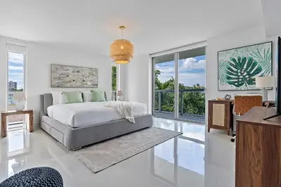 a bedroom with a bed and a large window at Bay Harbor One Vacation in Miami Beach