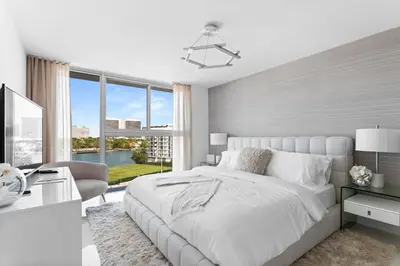 a white bedroom with a large bed and a desk at Bay Harbor One Vacation in Miami Beach