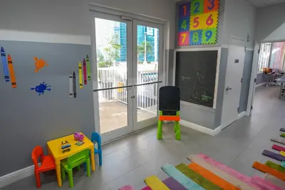 a room with a play room with a table and chairs at 4 bed full condo in Miami with skyline & sea view in Miami