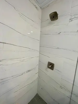 a bathroom with white marble walls and a shower at Modern Riverview Apartments in Fort Lauderdale