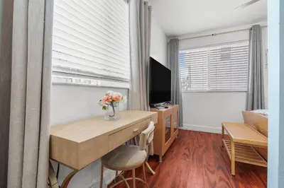 a room with a desk and a computer and a window at The Pearl Beachside Apartments on Hollywood Beach in Hollywood