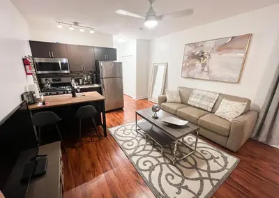 a living room with a couch and a kitchen at The Pearl Beachside Apartments on Hollywood Beach in Hollywood