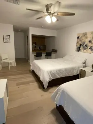 a bedroom with two beds and a ceiling fan at Cozy Downtown Apartments on Water in Fort Lauderdale