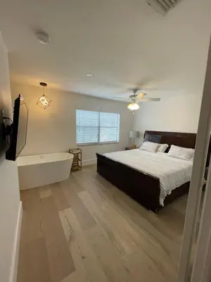 a bedroom with a bed and a bath tub at Cozy Downtown Apartments on Water in Fort Lauderdale