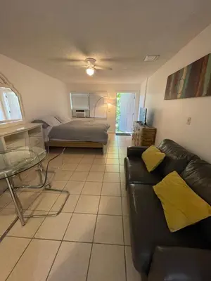 a living room with a couch and a bed at Cozy Downtown Apartments on Water in Fort Lauderdale