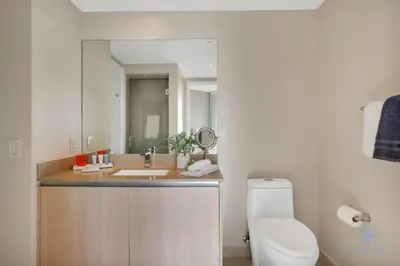 a bathroom with a sink and a toilet and a mirror at Insane Ocean View Balcony - Beachfront Resort - Pools in Hollywood
