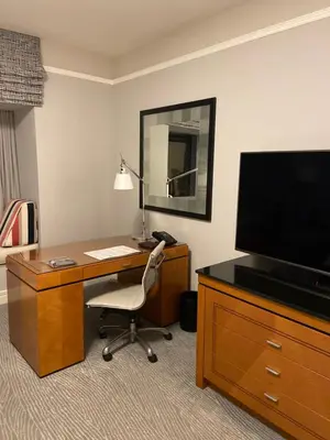 a desk with a television and a chair in a room at Four Seasons Hotel Miami - Luxury Private Residences in Miami