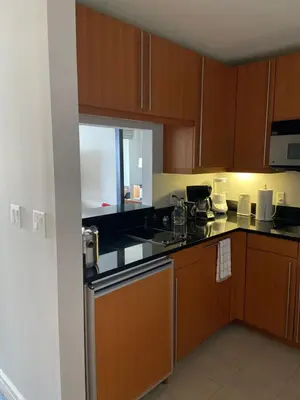 a kitchen with wooden cabinets and a counter top at Four Seasons Hotel Miami - Luxury Private Residences in Miami