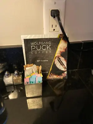 a box of doughnuts and a book on a counter at Four Seasons Hotel Miami - Luxury Private Residences in Miami
