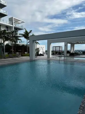 a large swimming pool in front of a building at BRAND NEW TOP FLOOR IN THE HEART OF MIAMI in Miami
