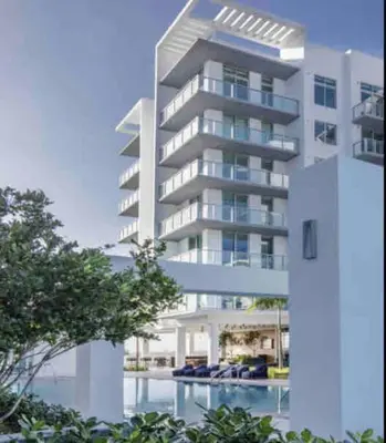 a large white building with a swimming pool in front of it at BRAND NEW TOP FLOOR IN THE HEART OF MIAMI in Miami