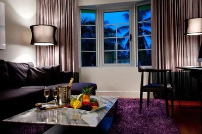 a living room with a table with a bowl of fruit at Leslie Hotel Ocean Drive in Miami Beach