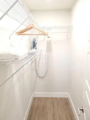 a white bathroom with white walls and a wooden floor at The Hideaway at Lake Ridge 3 in Fort Lauderdale