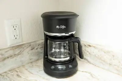 a black coffee maker sitting on a counter at The Hideaway at Lake Ridge 3 in Fort Lauderdale