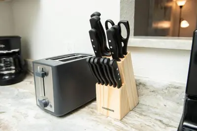 a knife block filled with knives next to a toaster at The Hideaway at Lake Ridge 3 in Fort Lauderdale