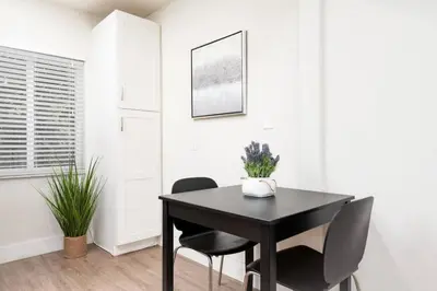 a dining room with a black table and chairs at The Hideaway at Lake Ridge 1 in Fort Lauderdale