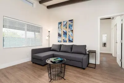 a living room with a couch and a table at The Hideaway at Lake Ridge 1 in Fort Lauderdale