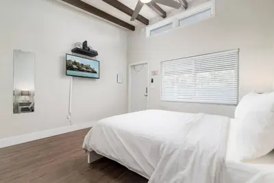 a white bedroom with a bed and a window at The Hideaway at Lake Ridge 2 in Fort Lauderdale